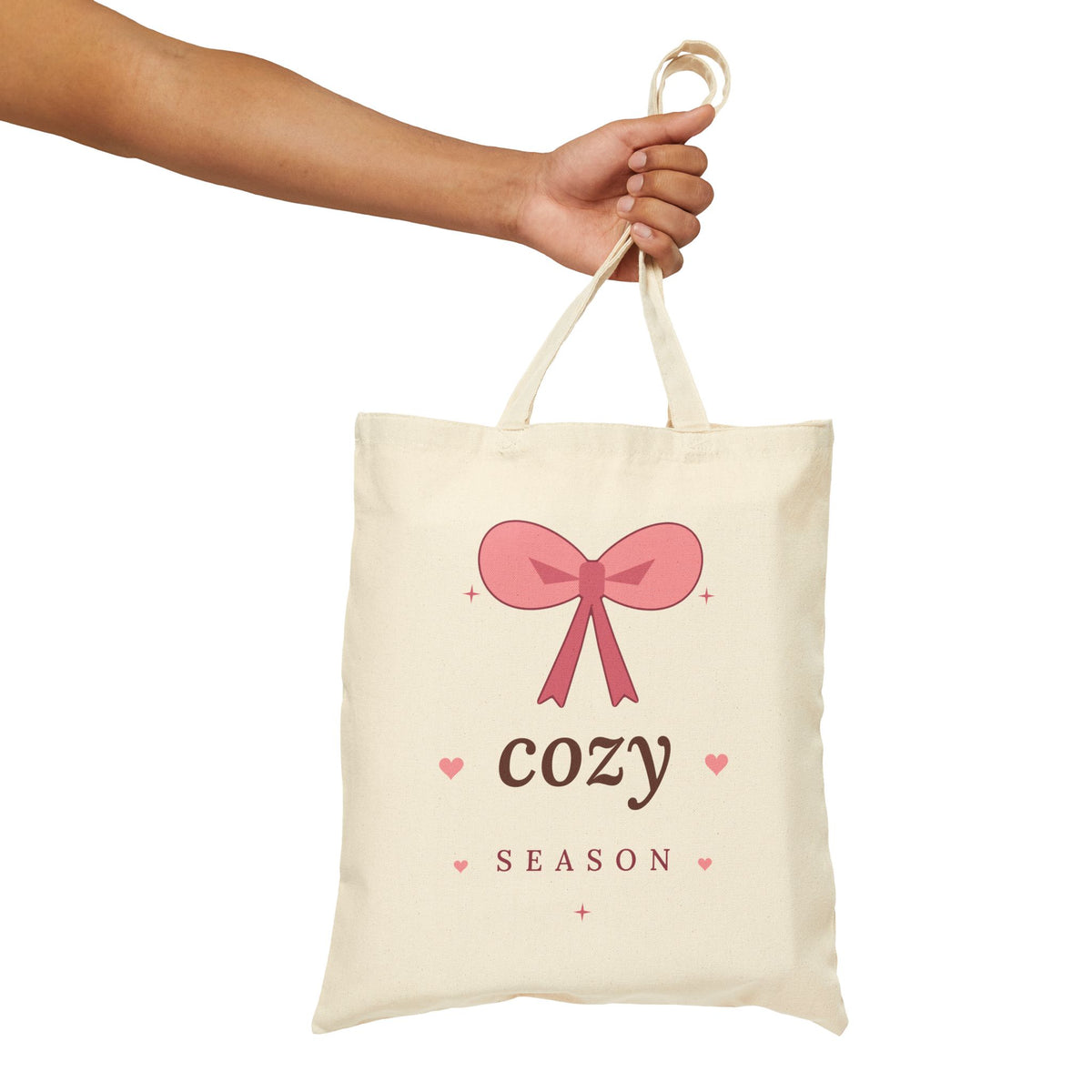 Cozy Season Canvas Tote Bag, natural, held up by hand