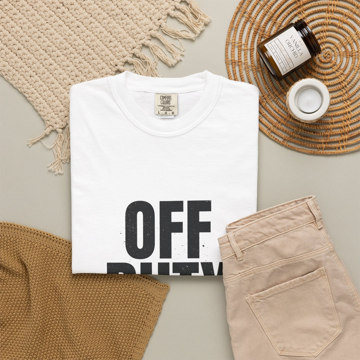 OFF DUTY Graphic T-Shirt, white, styled flat lay with beige pants and a woven blanket for a casual off-duty look.
