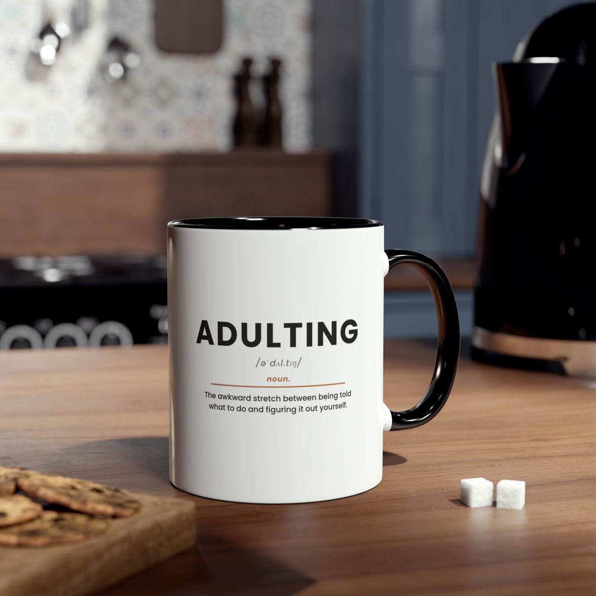 Adulting Definition Coffee Mug, Black, lifestyle photo on kitchen counter